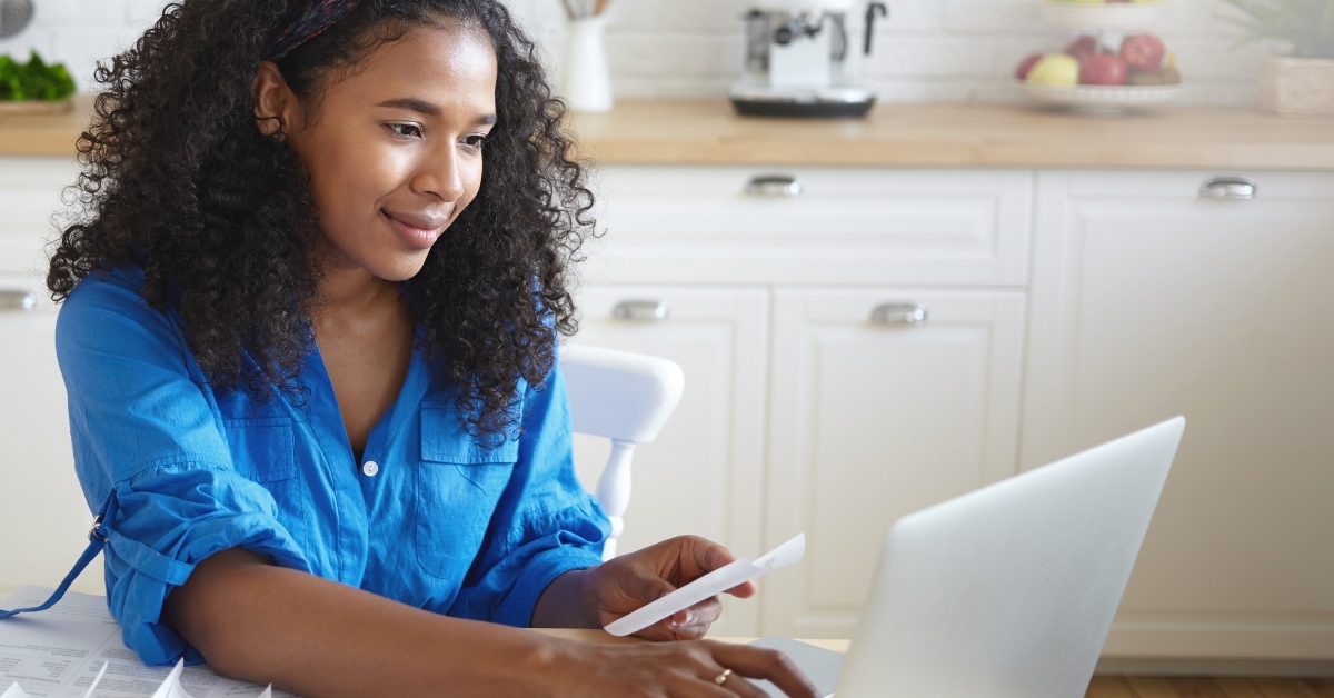 housewife wearing headband and casual shirt paying utility bills
