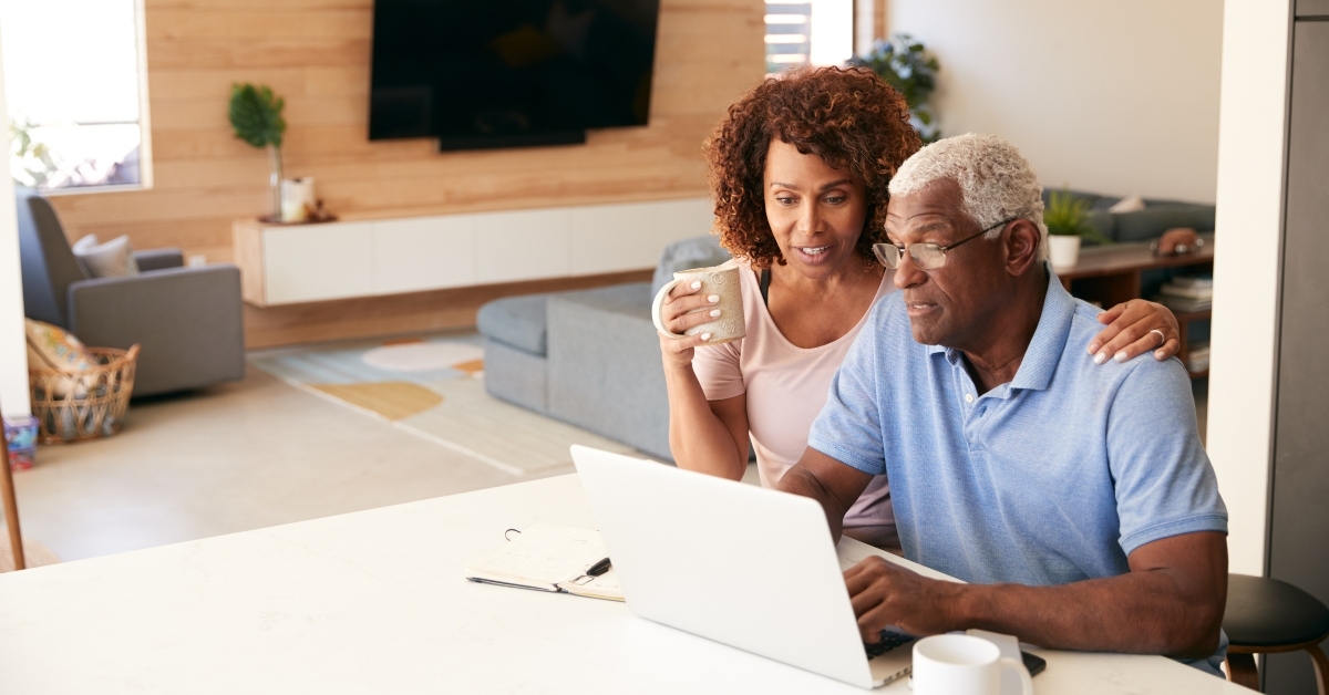senior couple using laptop to check finances