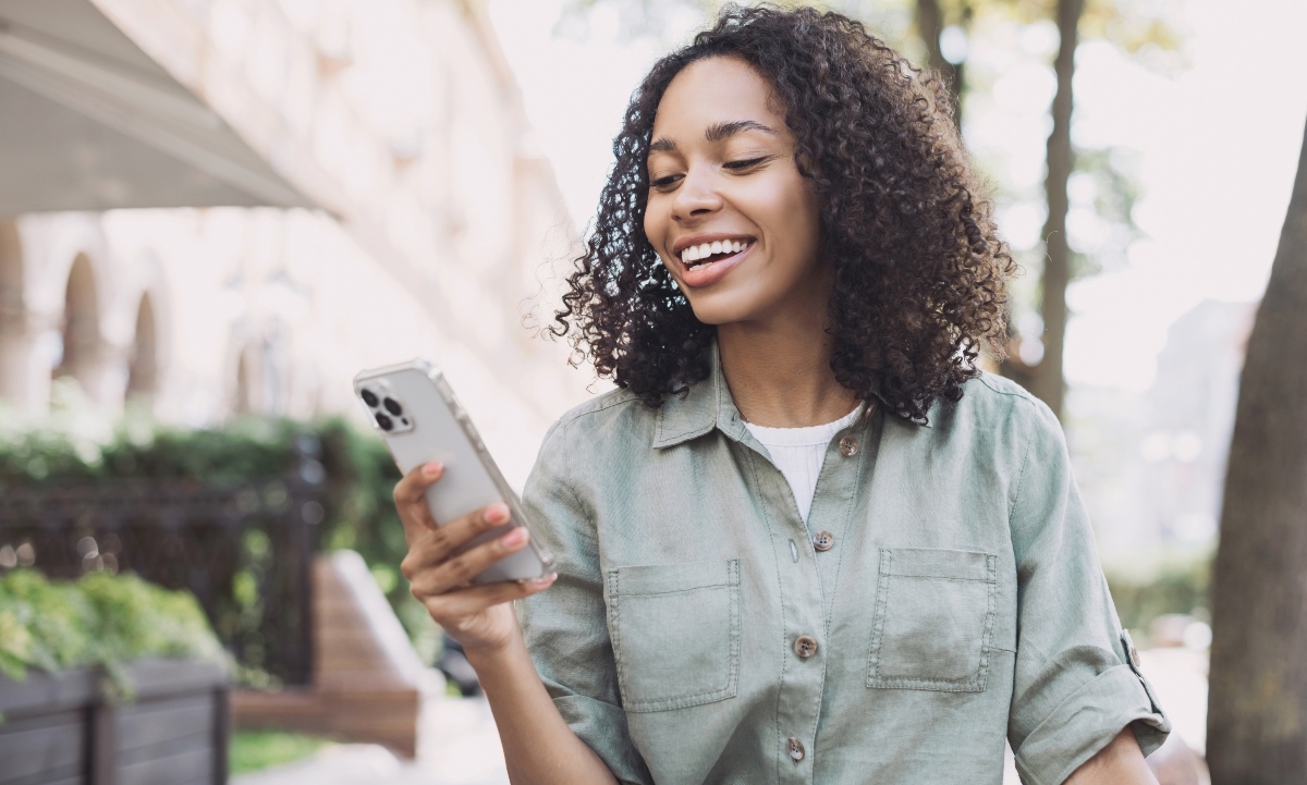 Woman smiling and looking at phone
