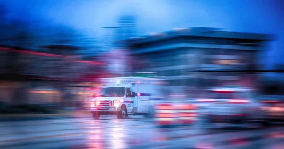 an ambulance racing through the rain