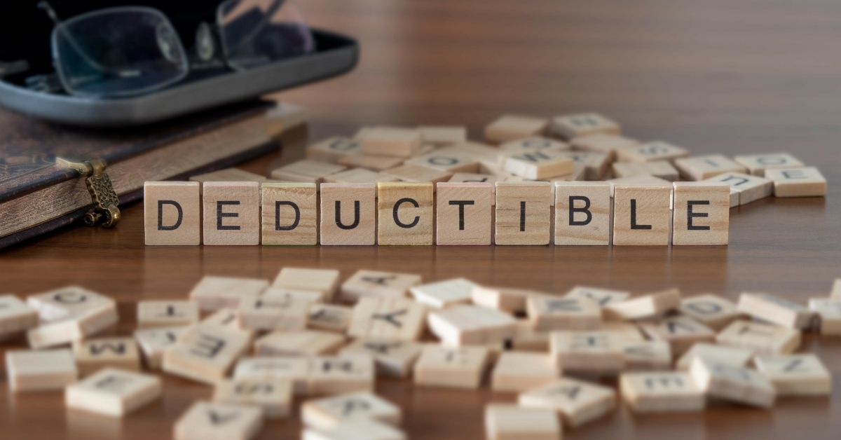 deductible word in wooden letter tiles