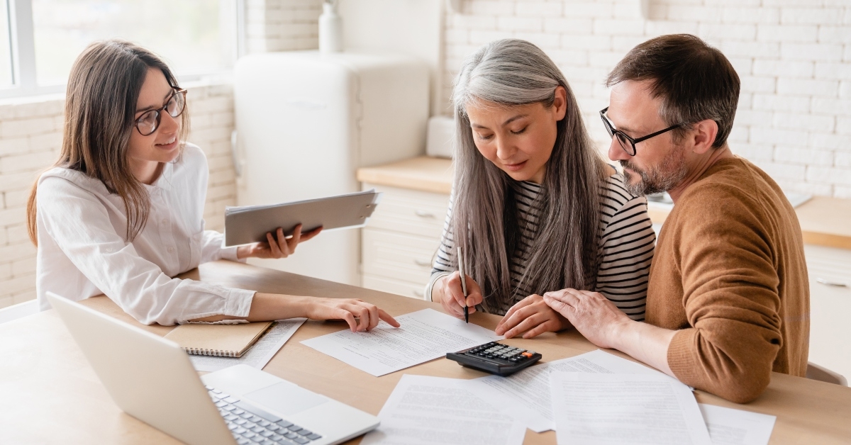 insurance agent consulting mature family couple