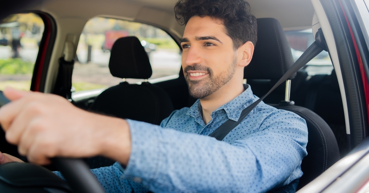 man driving his car on way to work