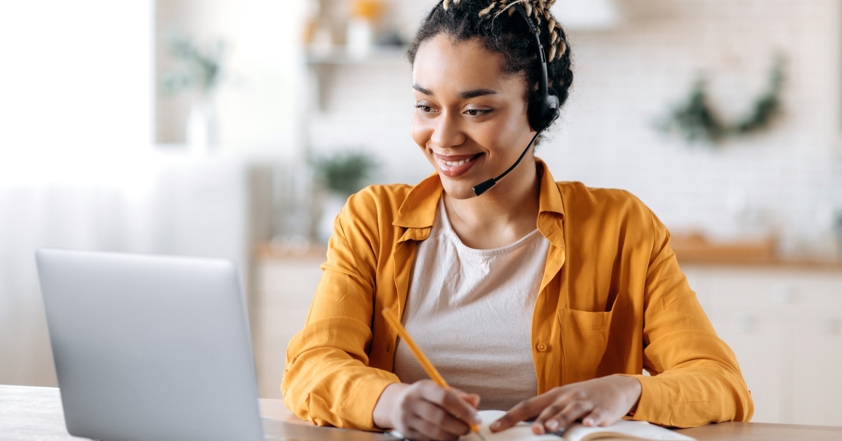female call center operator with headset and laptop