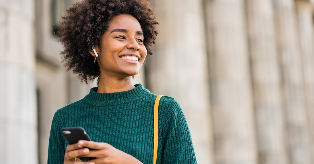 Smiling woman holding phone