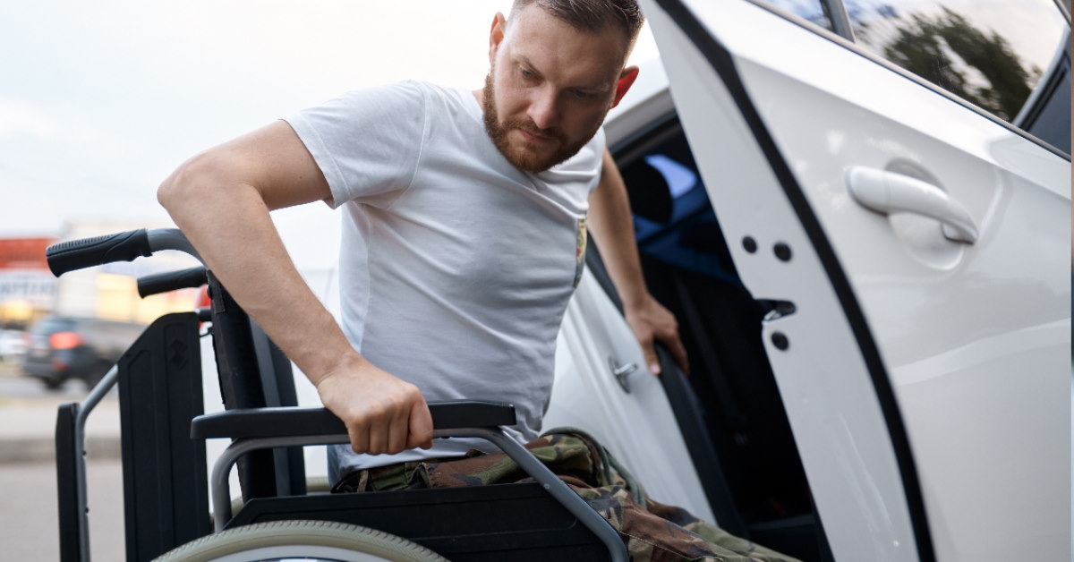 retired veteran sitting on wheelchair trying to get into car outside during day time