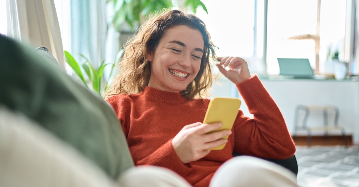 Woman playing on mobile phone