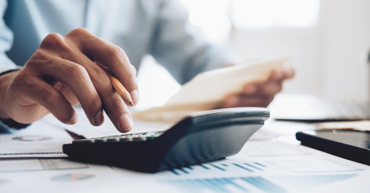male accountant using calculator