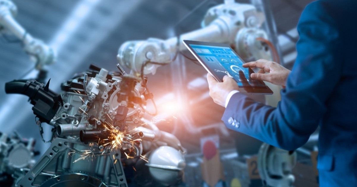 engineer checking and controlling automation robot arms