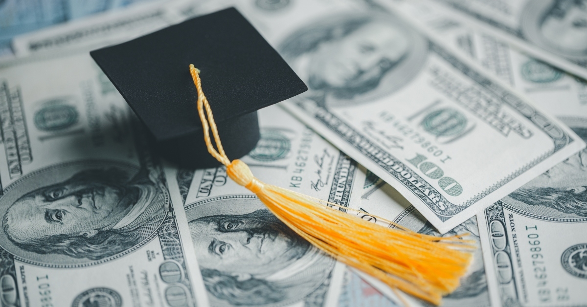 graduation hat on dollar banknotes