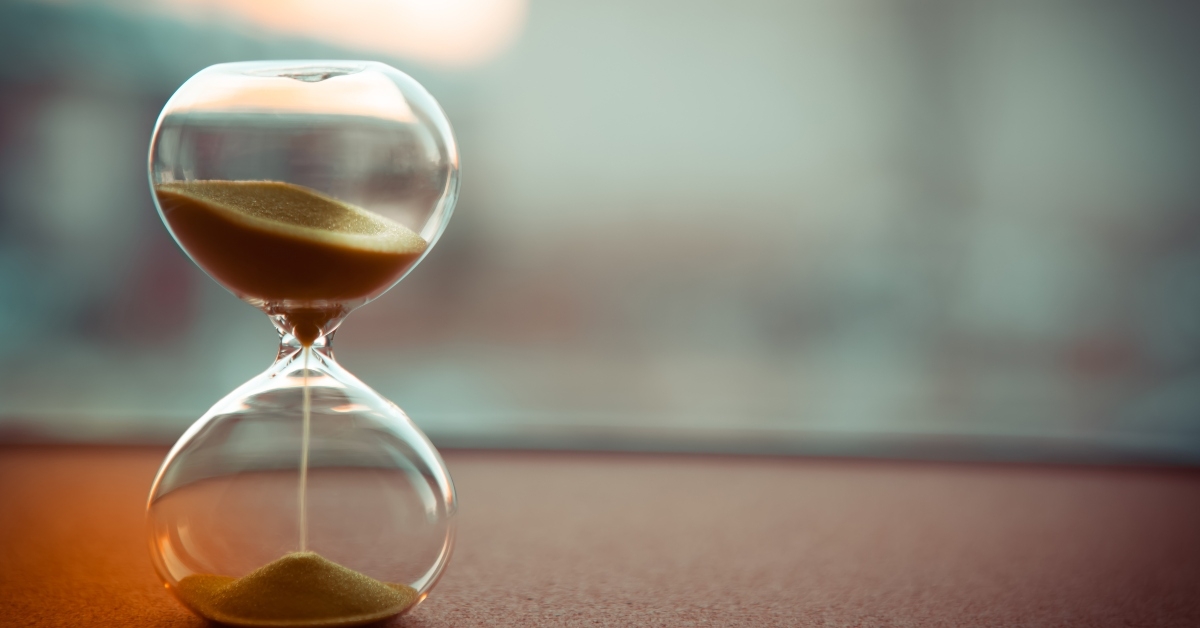 sand running through the bulbs of an hourglass