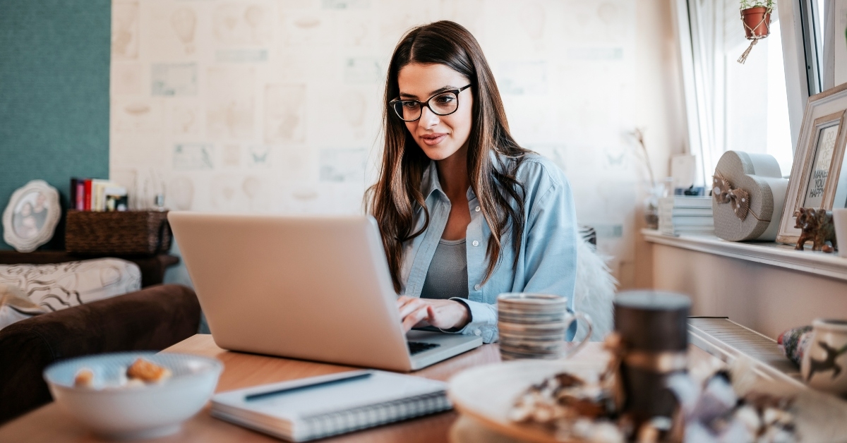 young woman studying on laptop at her apartment