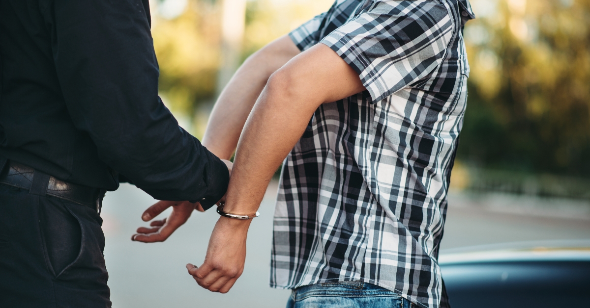 policeman arrests the car thief on road