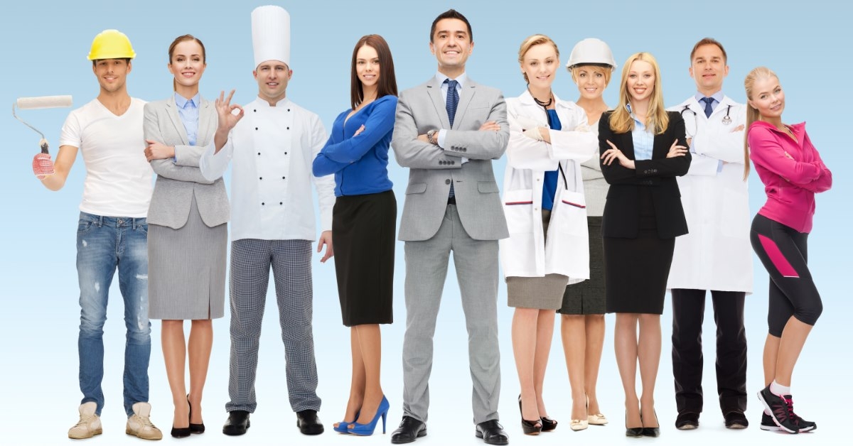 businessman at front smiling along with other professional workers