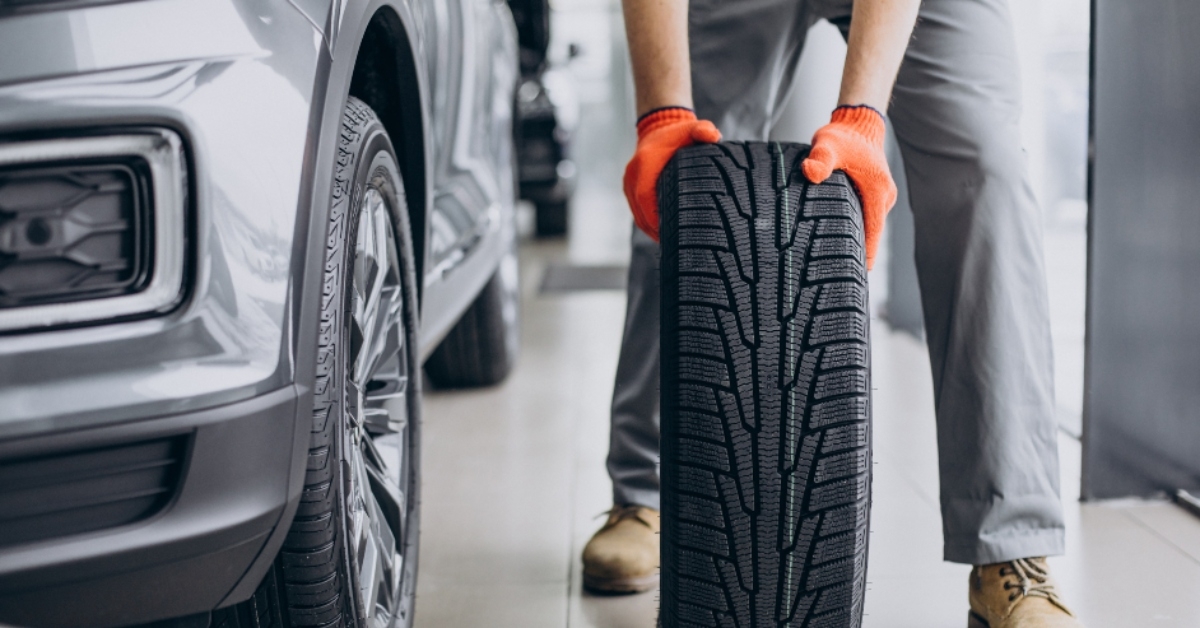 mechanic changing tires in a car service