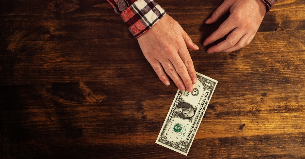 female hands and one dollar tip