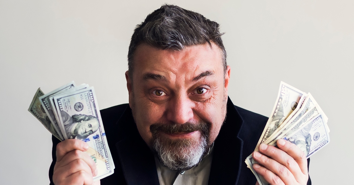 happy bearded man with dollars in his hands