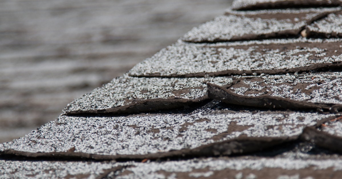 asphalt shingles on roof of a house worn out due to weather changes