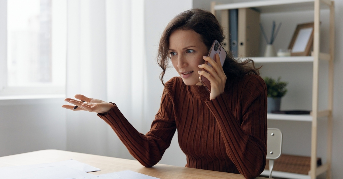 angry lady talks with frauds via phone