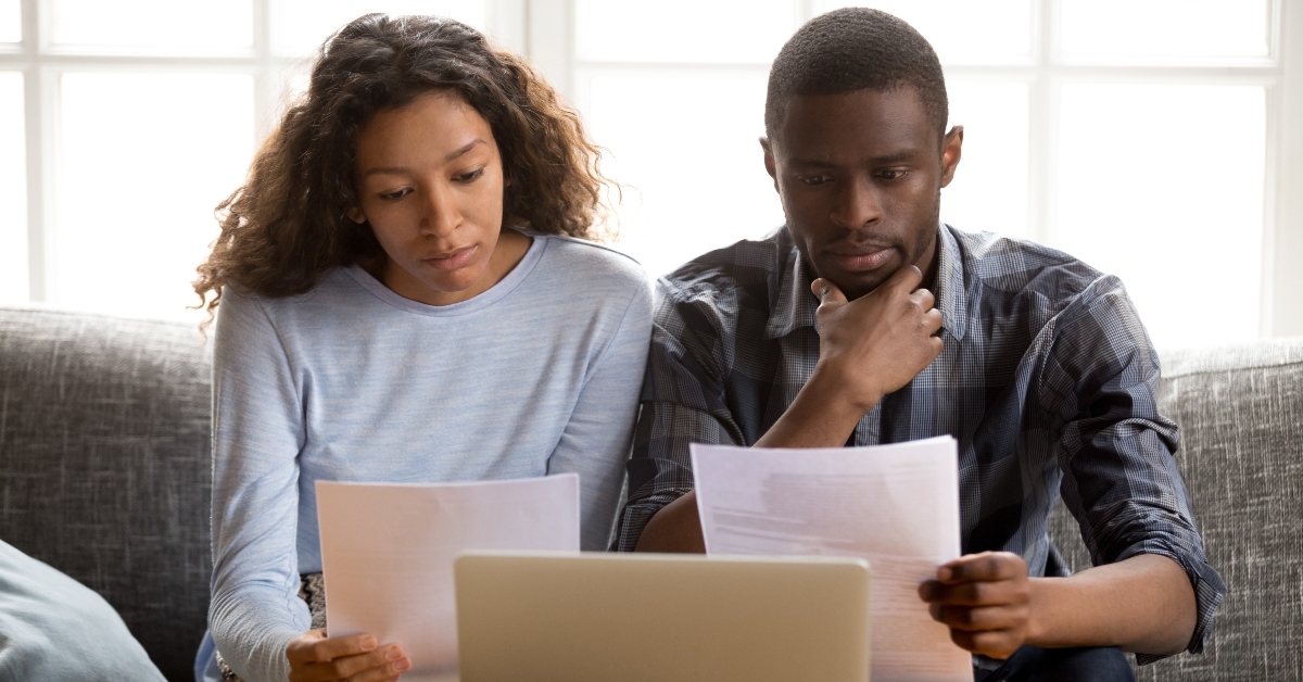 couple reading paper documents