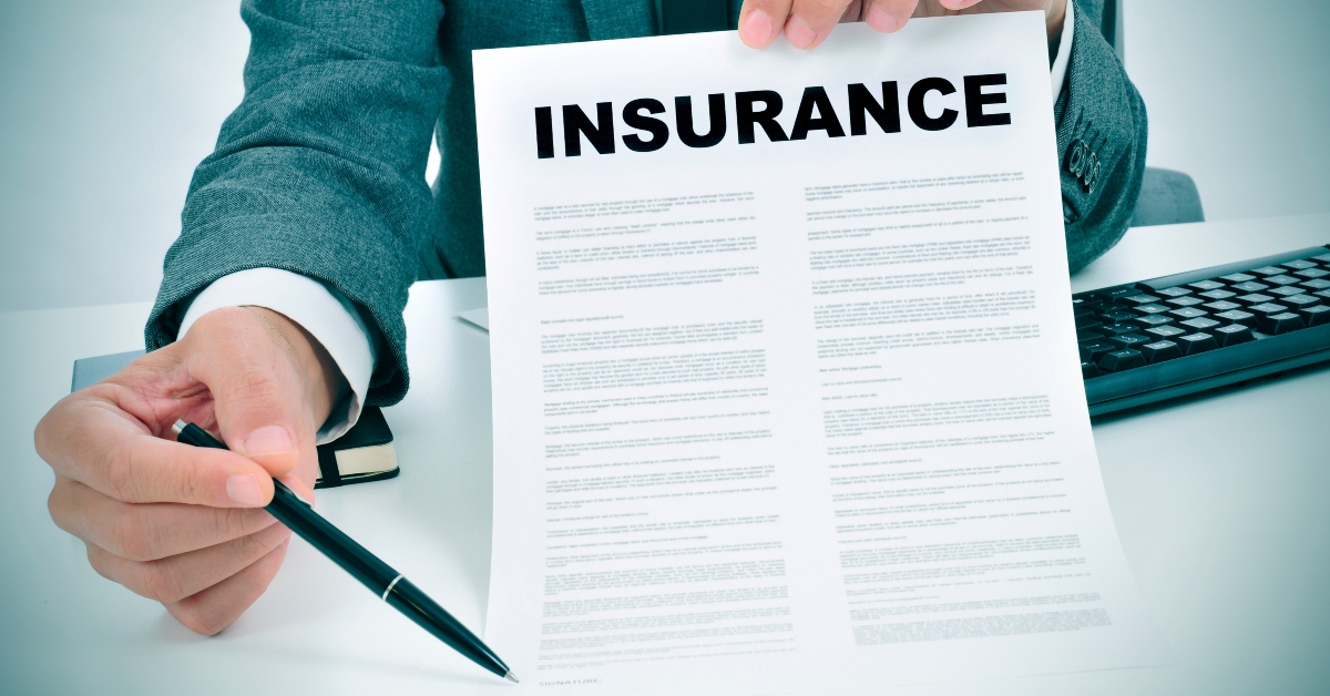 young man in suit showing an insurance policy