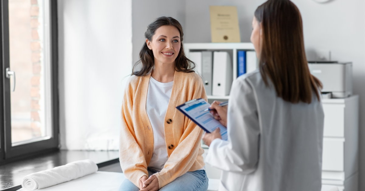female doctor using checklist to intervene a female patient on stretcher at clinic