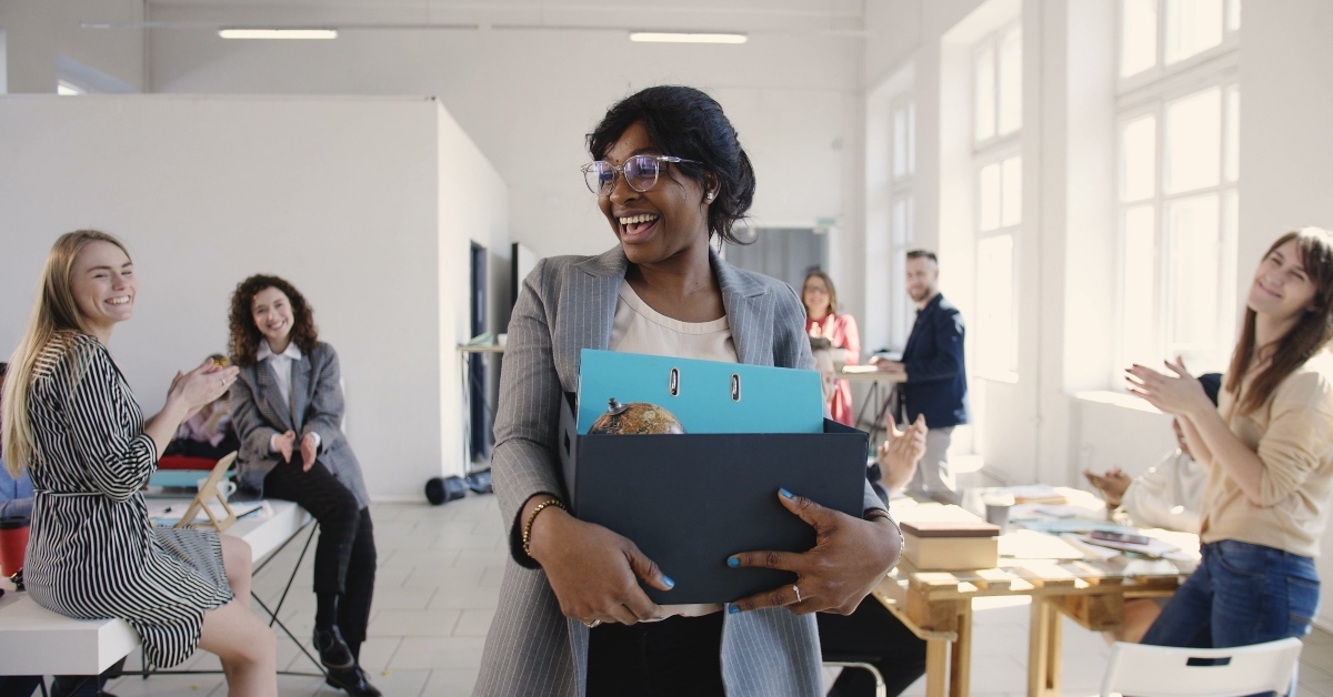 female manager carrying office box