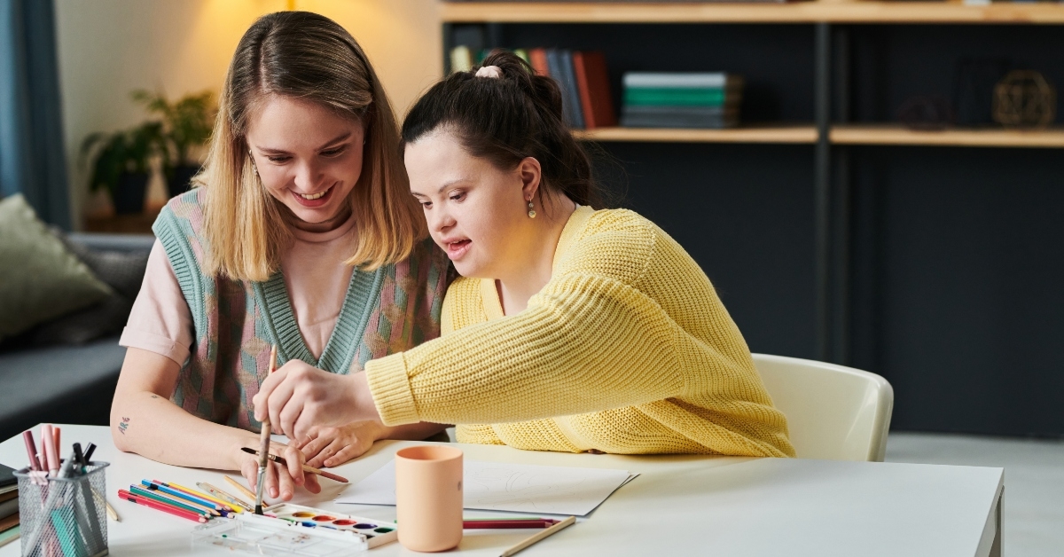 girl with down syndrome choosing watercolor paint