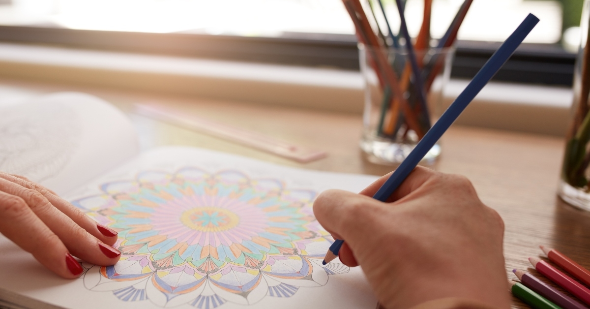 human hands drawing in adult coloring book