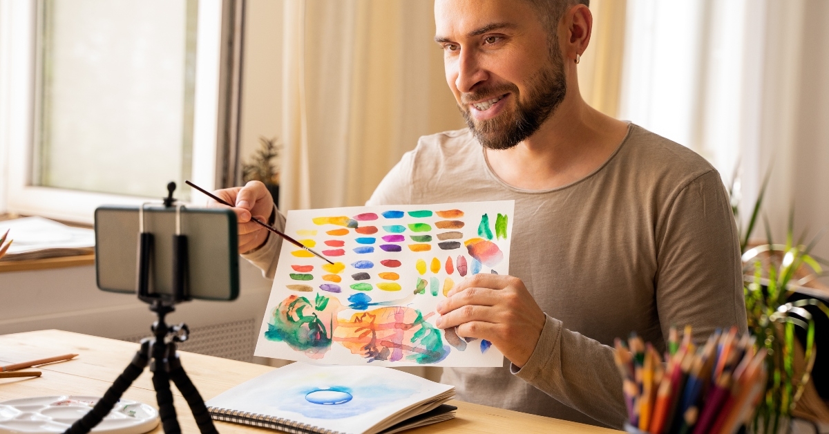 man smiling happy making online art class