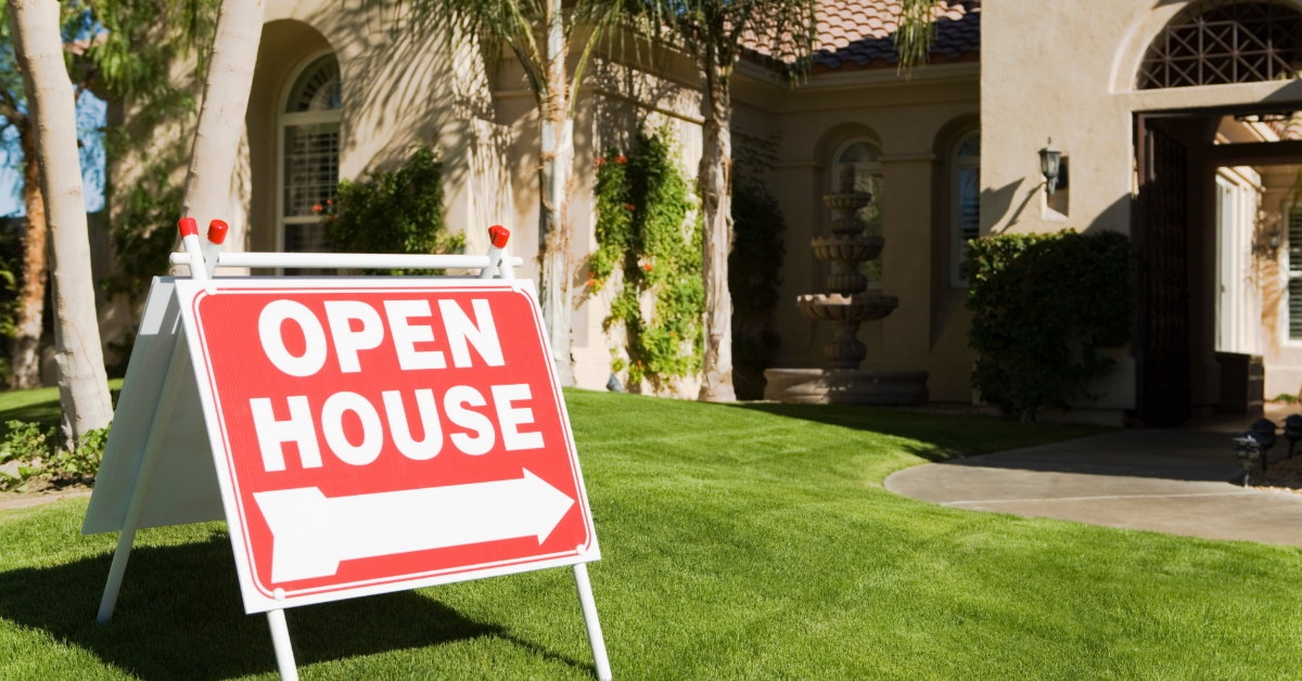 huge open house sign board outside new house during day time