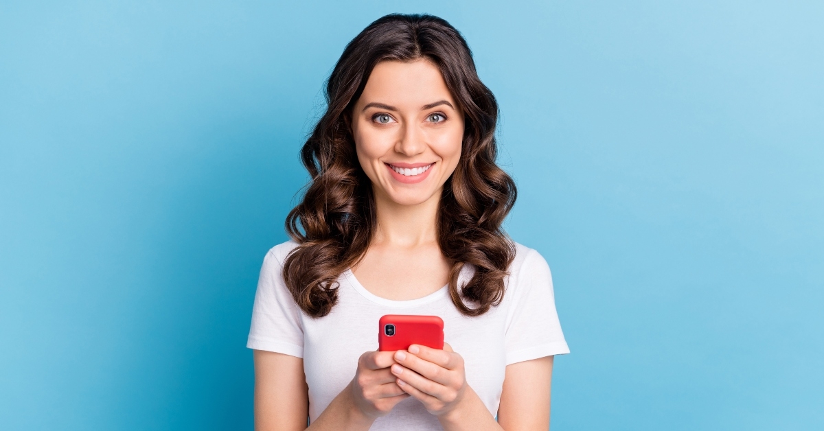 young woman wearing white t-shirt typing on mobile phone