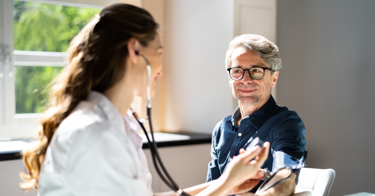 doctor measuring blood pressure of patient