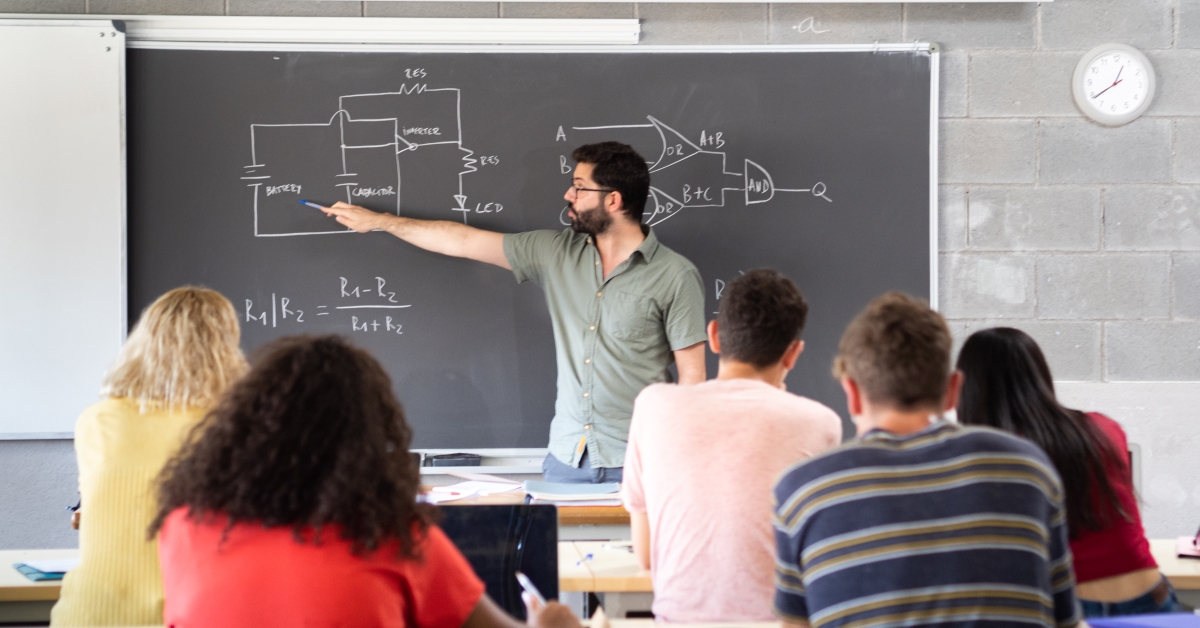 male teacher giving a science class 