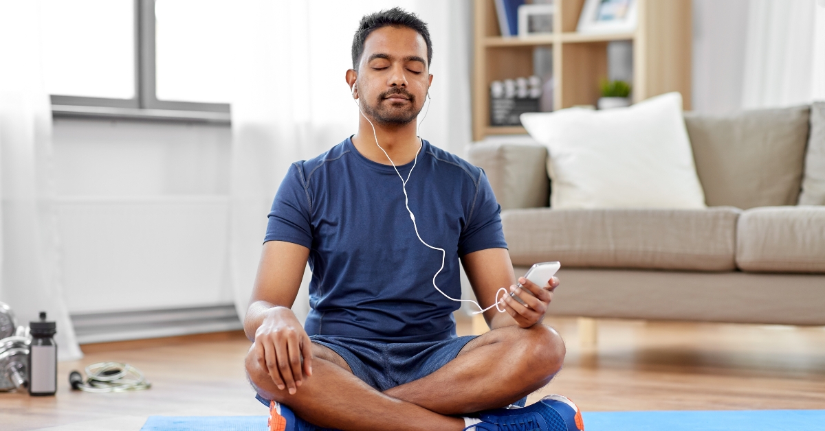 man in earphones listening to music on smartphone
