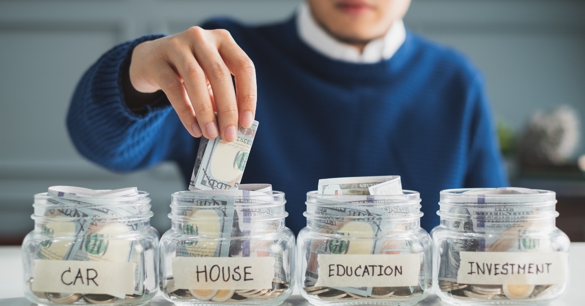man putting money in jar