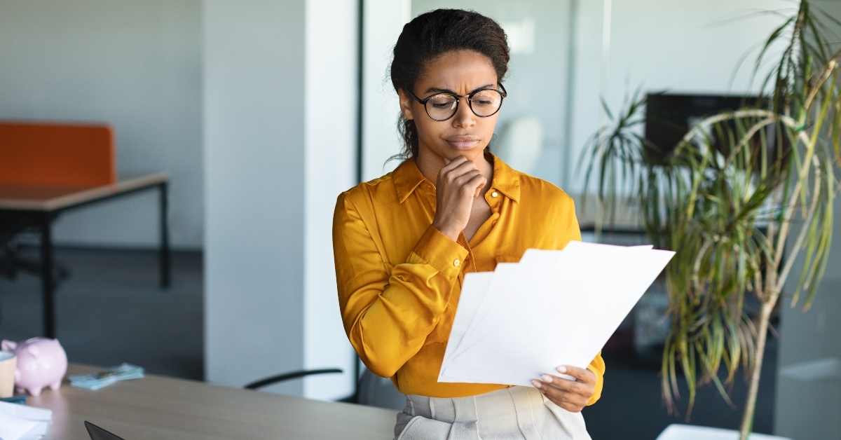 manager holding and reading financial documents