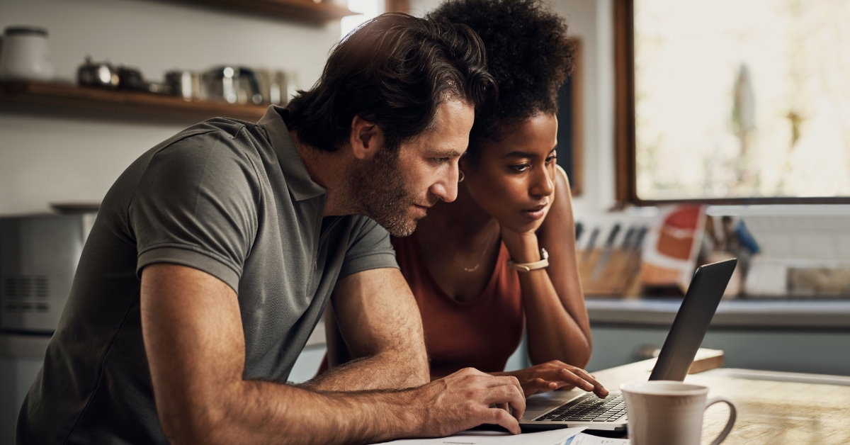 couple using laptop to find a solution for their problem