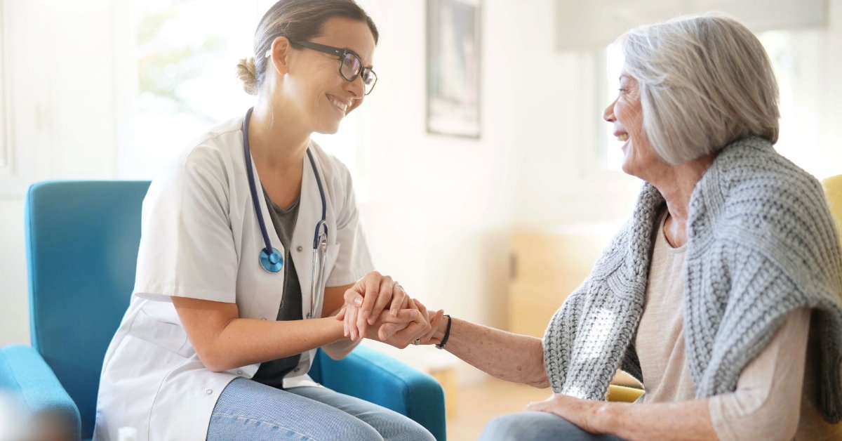 female doctor reassuring senior female patient