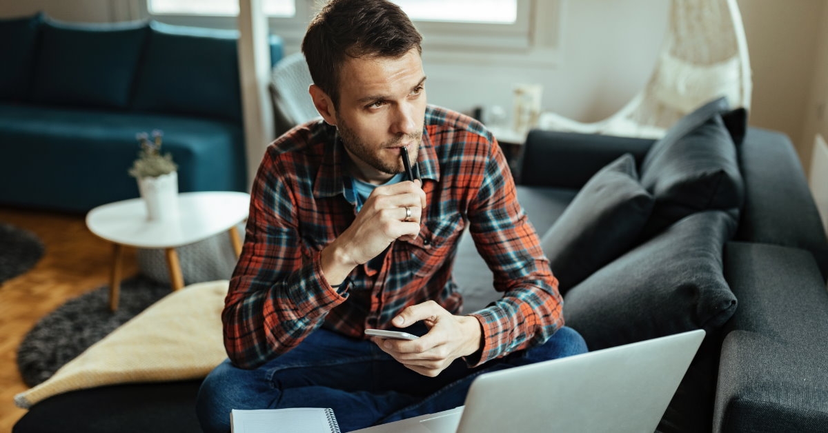 man working from home lost in thoughts 