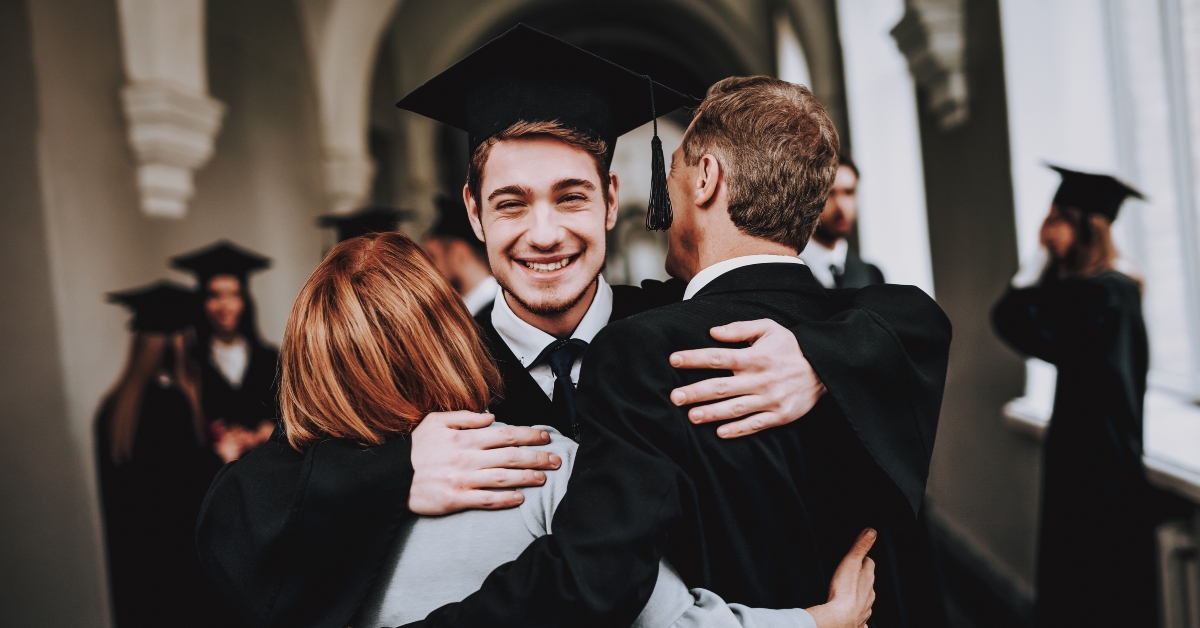 parents hug graduate son