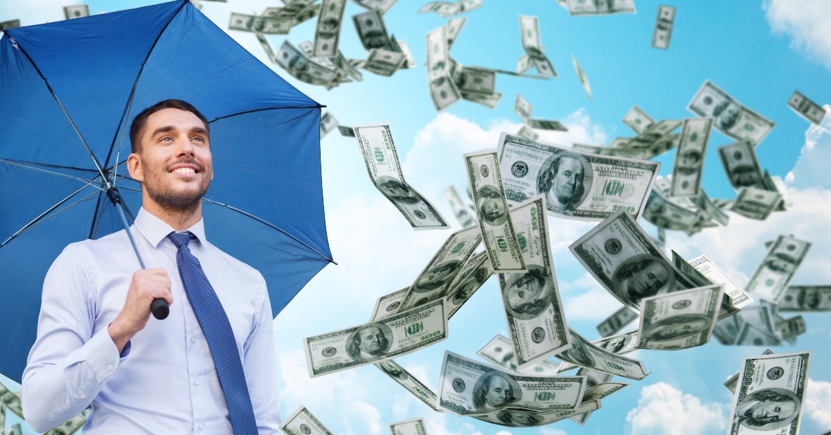 smiling businessman with umbrella outdoors