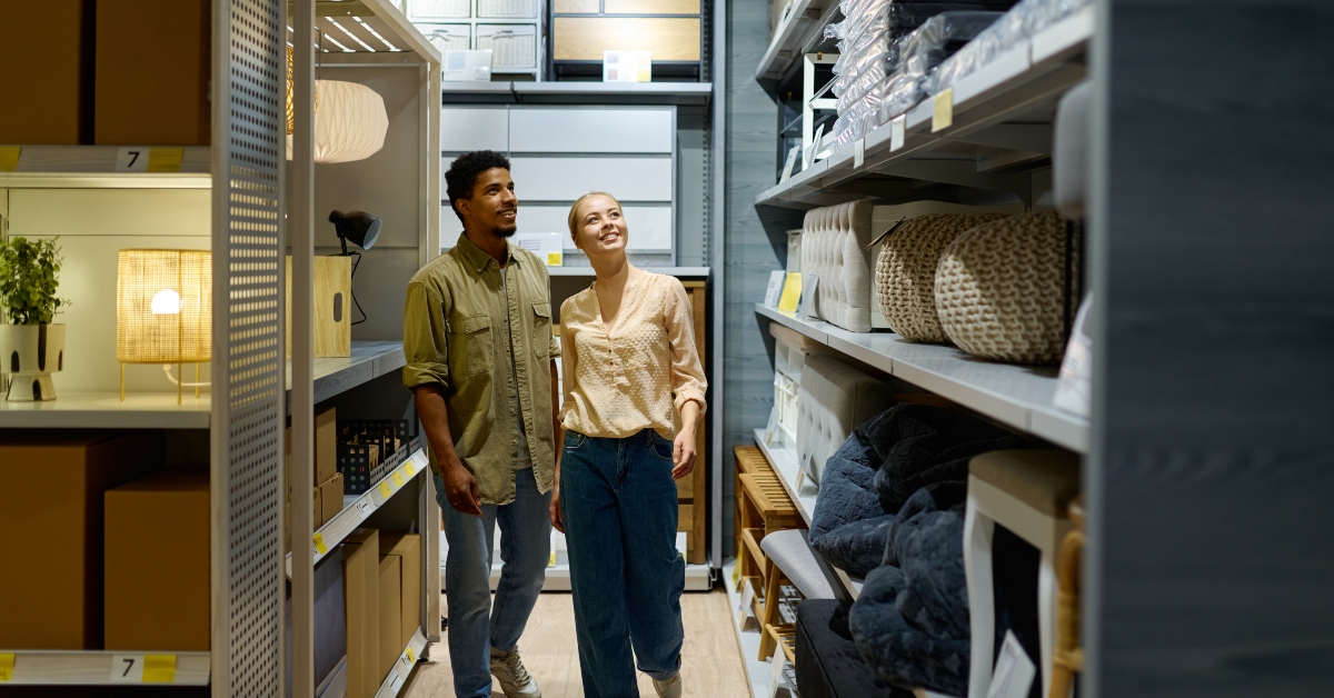 couple walking along showcase at furniture shop