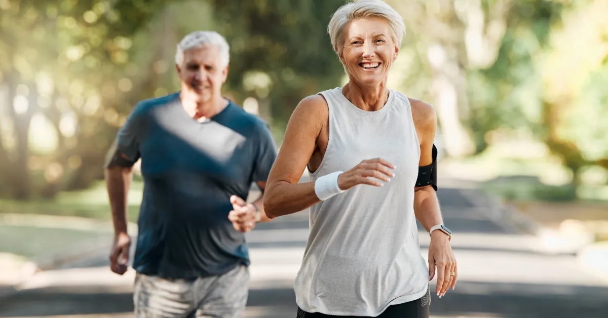 senior couple running in park