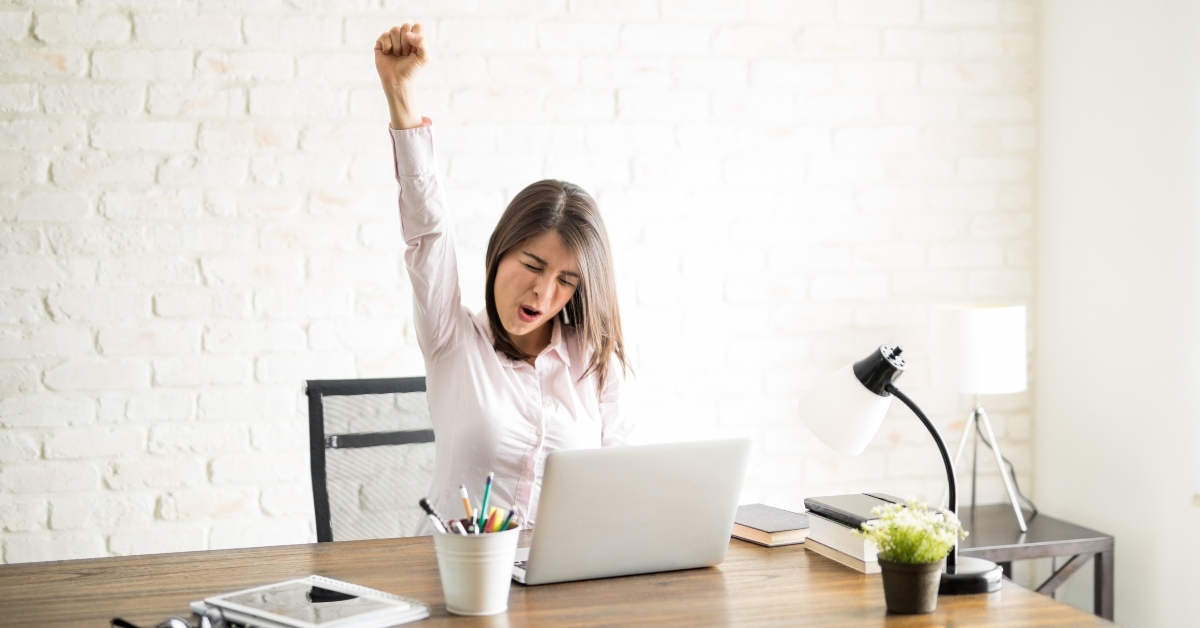 excited woman in an office