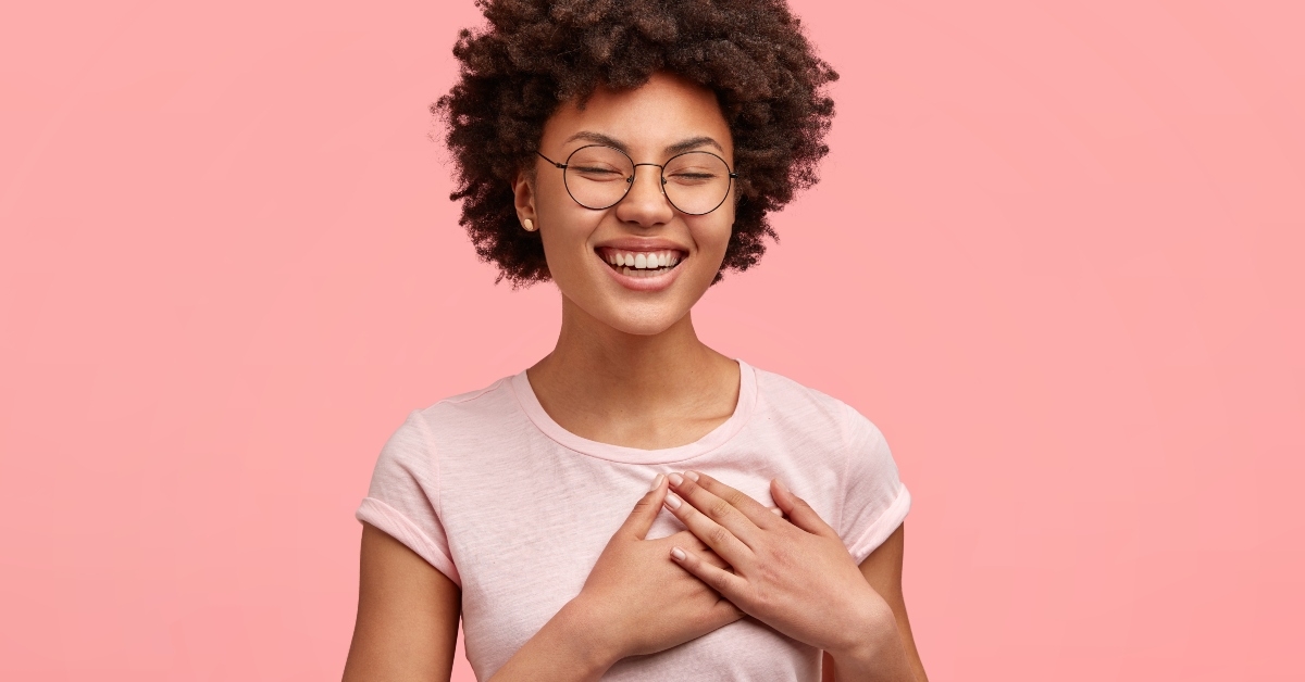 woman with Afro hair smiles sincerely 