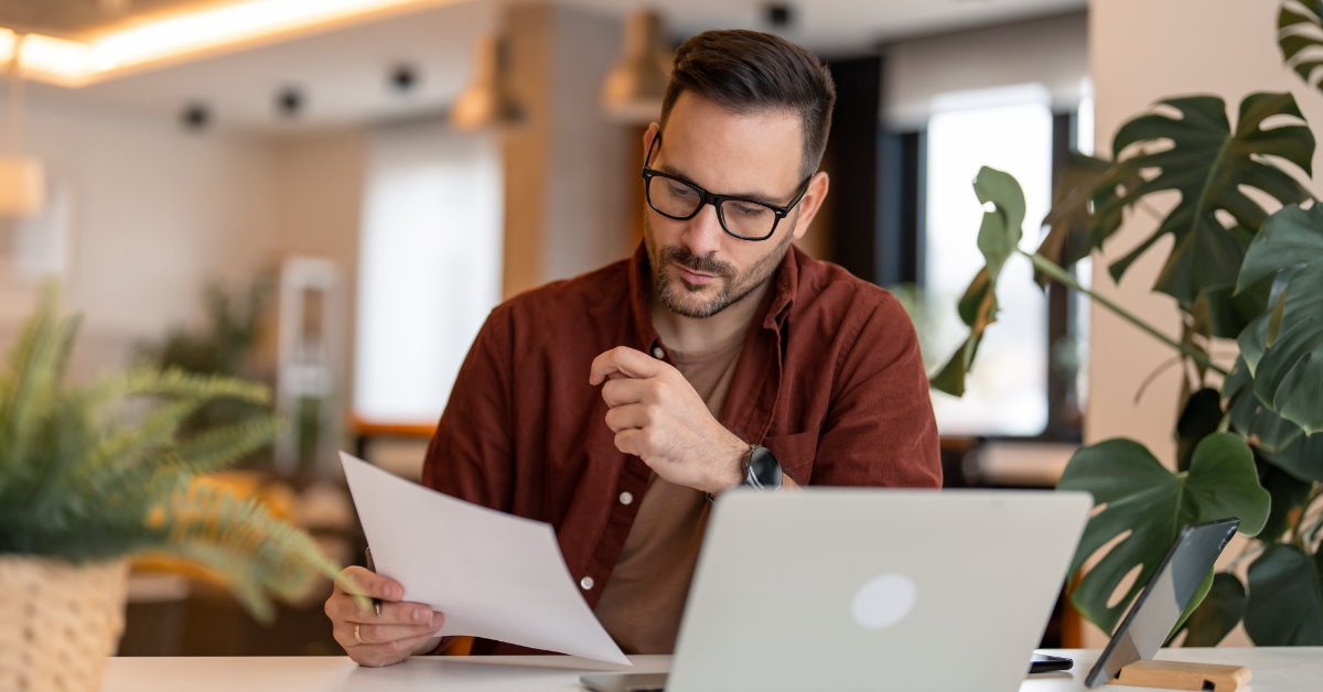 man sitting at table reviewing documents 