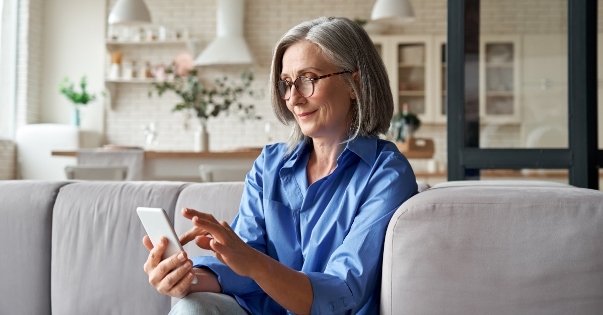 middle aged female holding smartphone