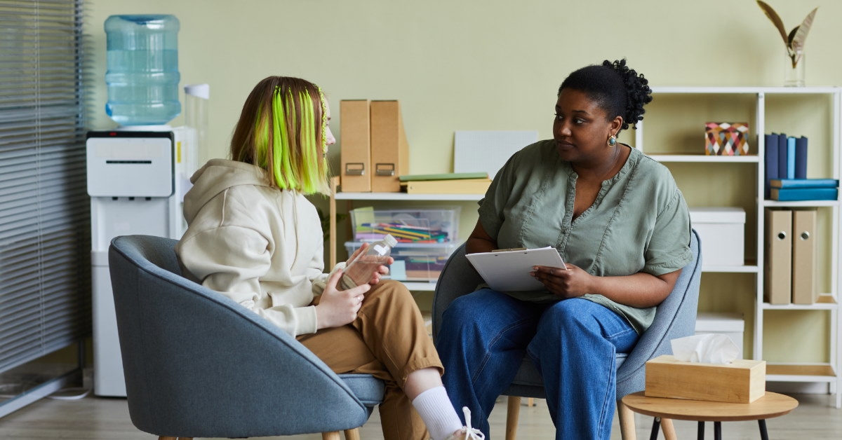 african american female counselor listening to student