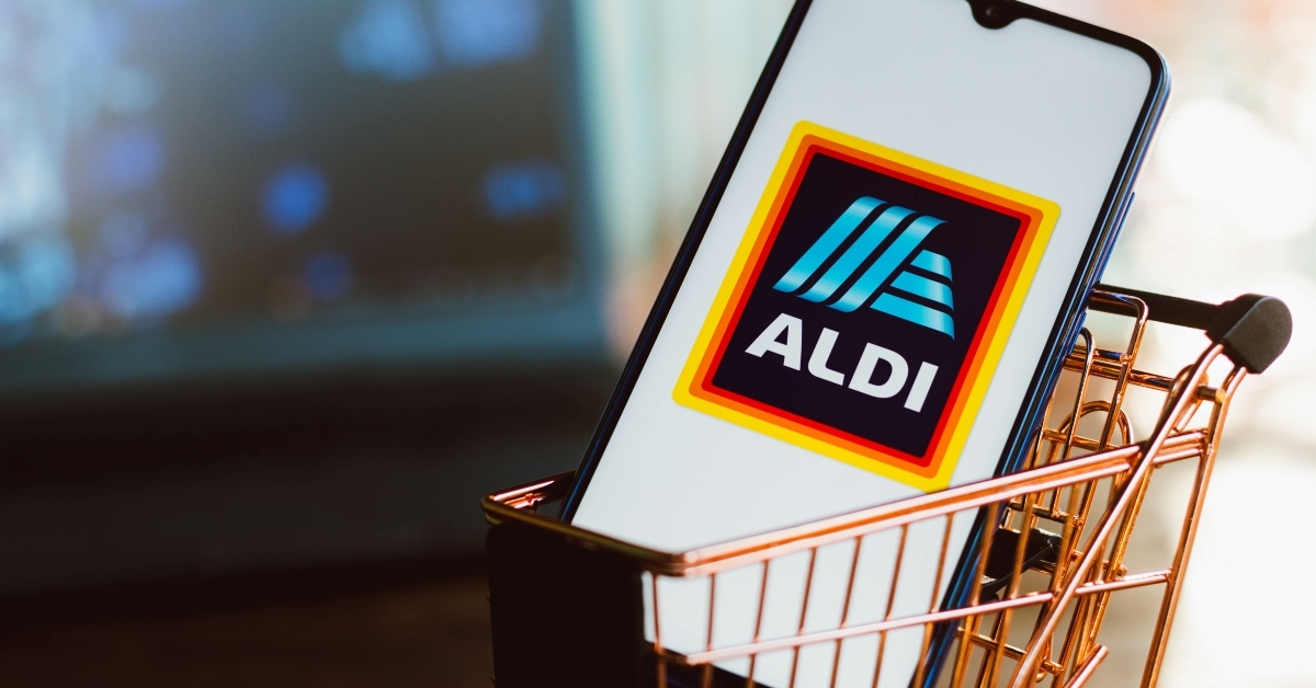 Aldi logo displayed on a smartphone along with a shopping cart